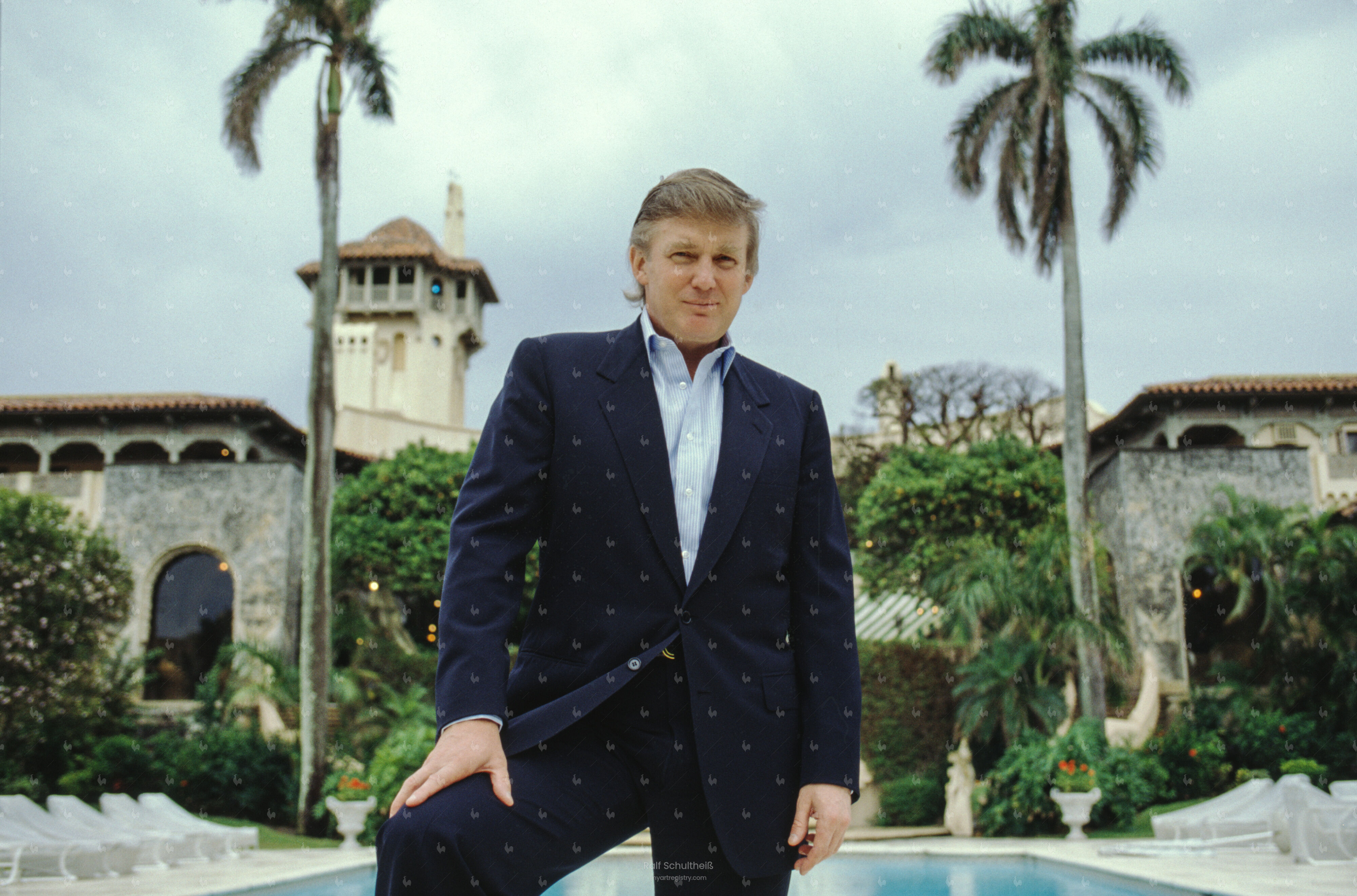 Donald Trump standing by the swimming pool in the garden of Mar-a-Lago