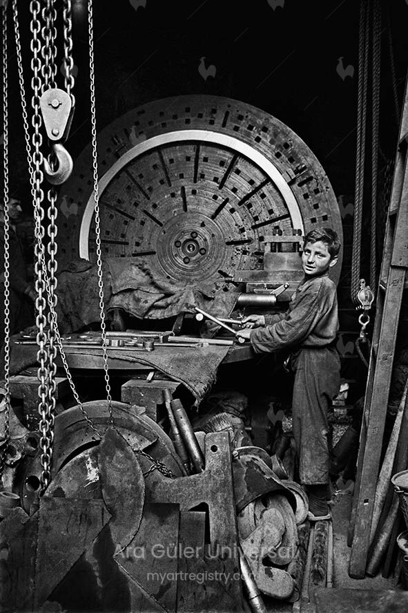 A boy is working on a machine